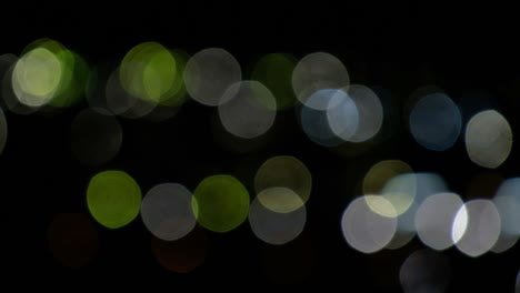 fondo de video bokeh de círculos de luz en negro. efecto de fugas de luz de la lente