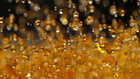 golden whisky splashes and creates standing waves, abstract liquid in macro and slow motion