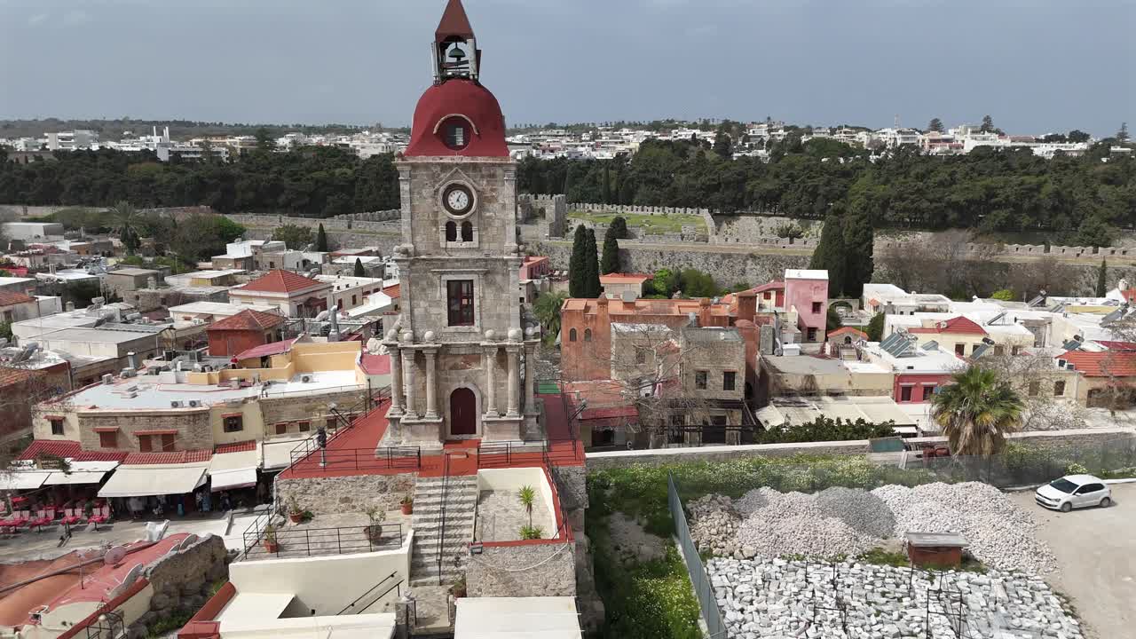 Aerial view forward towards Medieval Clock Tower (Roloi Clock Tower) in the city of Rhodes in Rhodes island in Greece.
