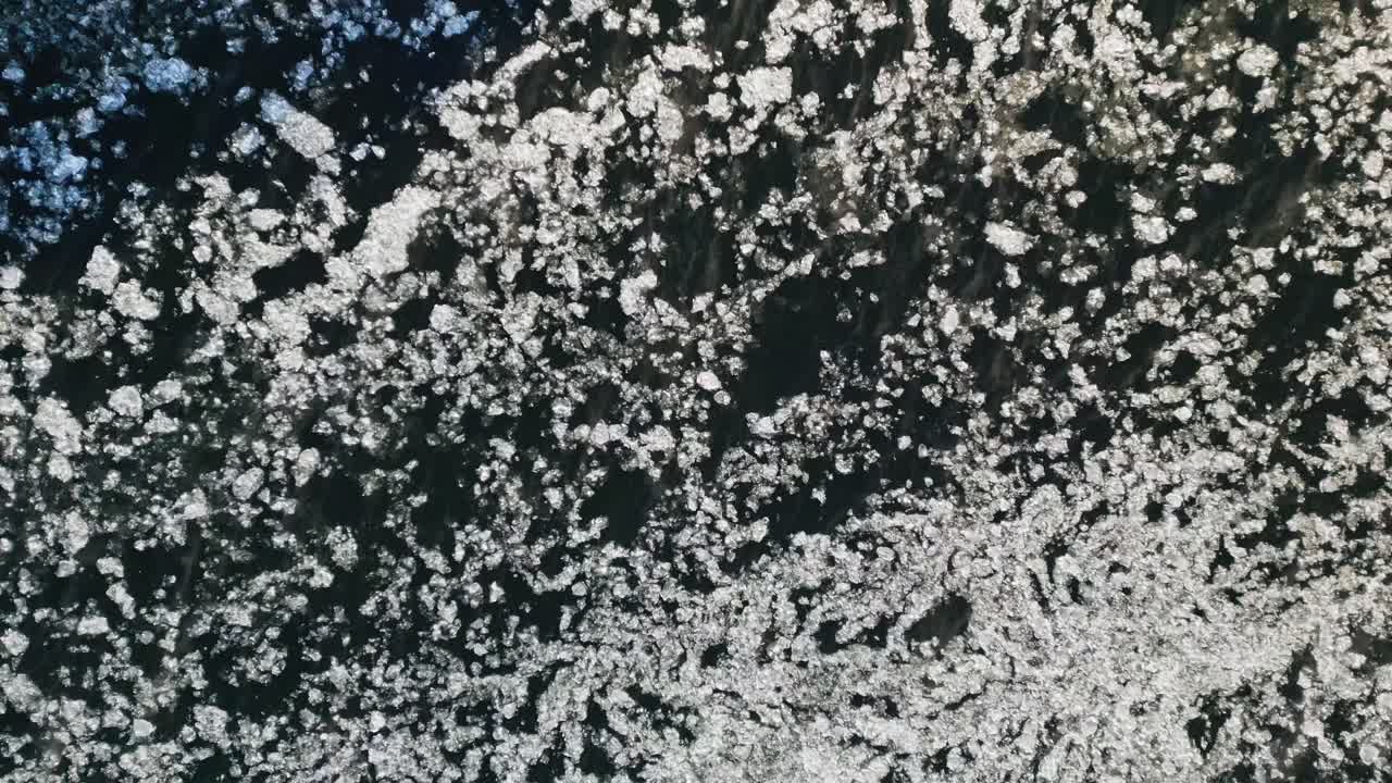 Frozen river with intricate ice sheets formations floating on deep water in winter, North America, Quebec, Montreal, Canada.