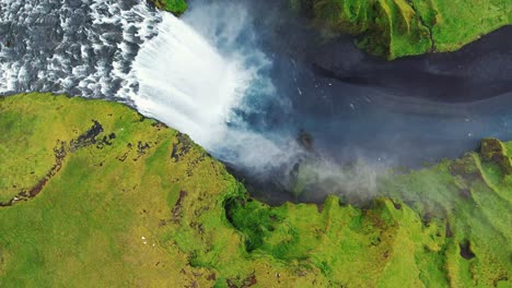 drone-circling-high-over-Skogafoss-waterfall,-iceland-in-4k