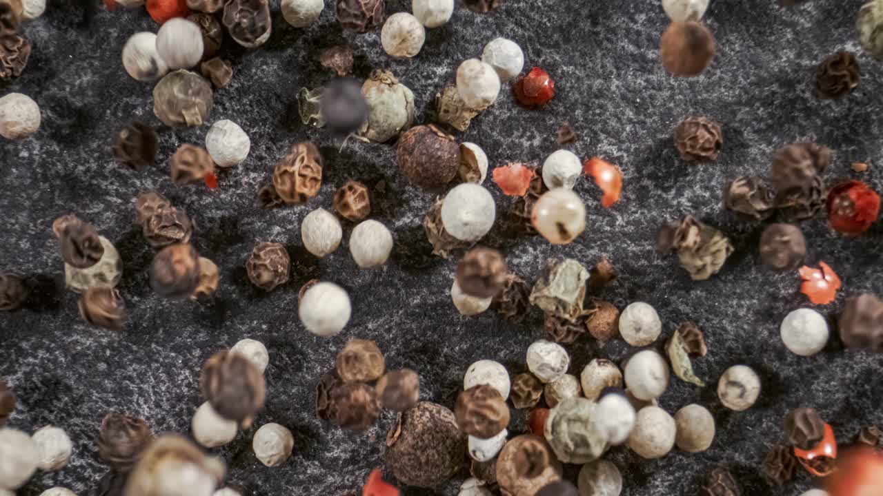 смесь перца в супер медленном движении. сухая смесь перца вблизи.