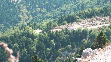 Mountain-road-in-Greece-while-a-cargo-truck-driving-down-the-hill