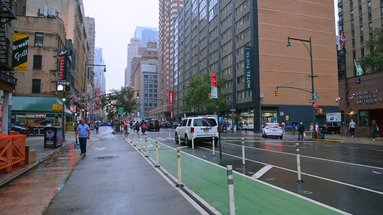 Cammina sul marciapiede nella strada di New York in un giorno di pioggia. Stile di vita di una città vivace. Vista sui grattacieli della metropoli