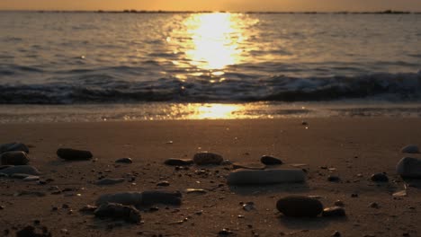 pebbles on a beach at sunset