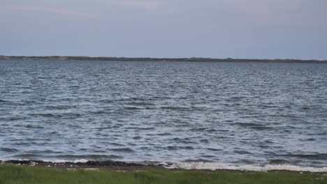 Slow-motion-view-of-gentle-waves-lapping-at-the-shore