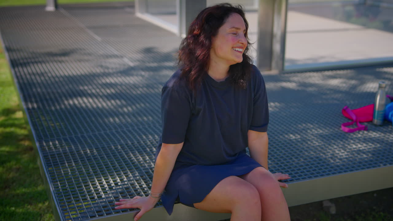 Woman sitting on a metal platform