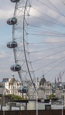 the london eye millennium wheel and skyline of london in vertical