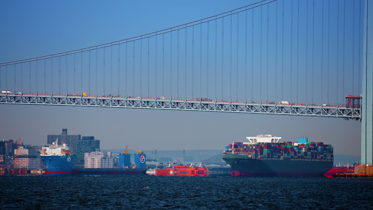 New York, USA, 28 December 2025: Container ship under Verrazzano Bridge New York. Large container ship passing under Verrazzano Narrows Bridge in New York Harbor