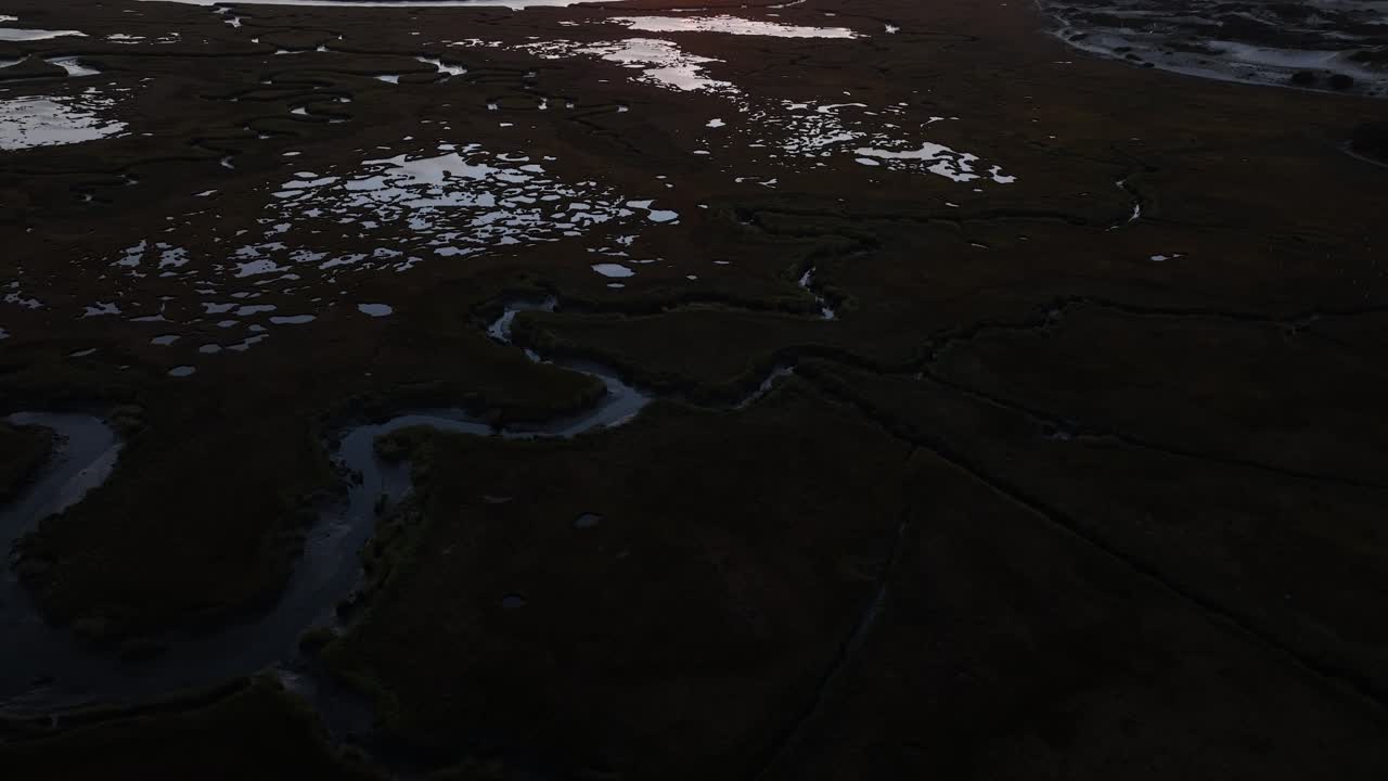 Salt marsh landscape at sunset with winding water channels in Cape Cod, Barnstable, Massachusetts
