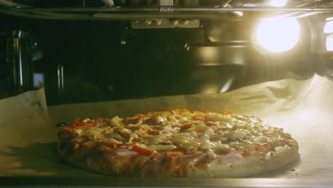 close-up of tasty pizza baking in a modern electric oven at the kitchen. stock footage. traditional italian food