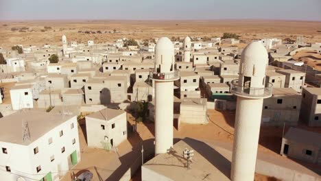 aerial shot revealing two mosques at palestine near gaza in the desert at an empty city