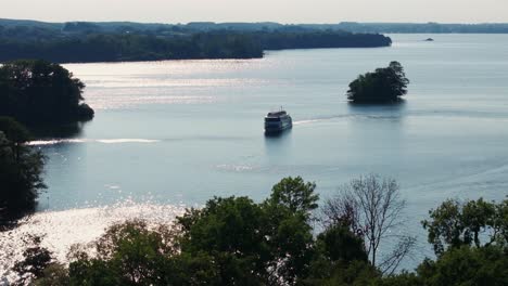 boat in between islands on sunny day with beautiful waters