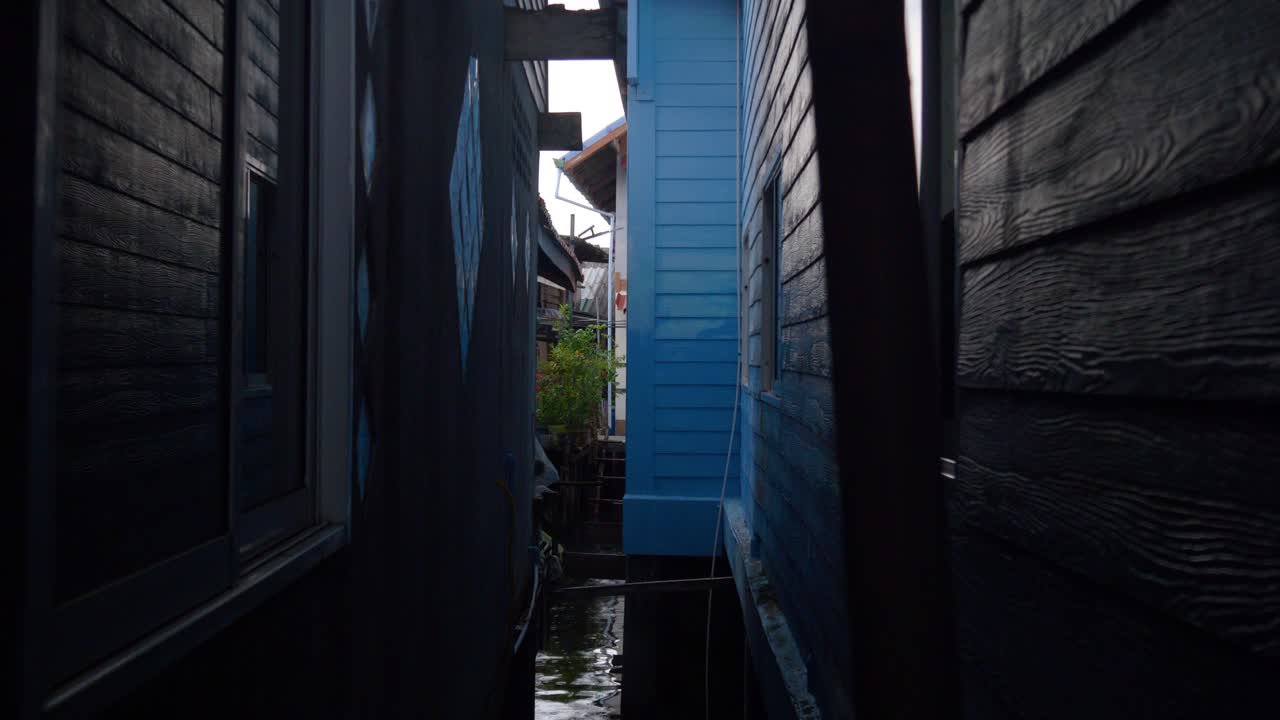 Narrow path between wooden houses in a Thai Muslim fishing village over water