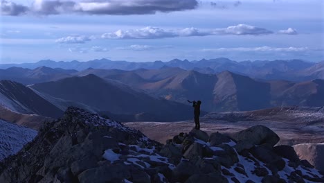 shofar ram horn music blown from hiker top of rocky mountains summit jewish christian tradition walls of jericho mt mount shavano elbert huron peak central colorado aerial drone sunset snow parallax