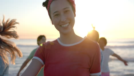 young caucasian woman smiles at the beach during sunset at a party