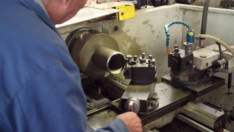 close up of engineer using lathe in manufacturing plant