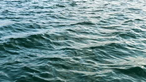 blue ocean waves seen from a traveling boat - close up