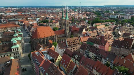 4k aerial drone video of the twin spiers and stained glass windows of the beautiful st. sebald church in downtown nurnberg, germany