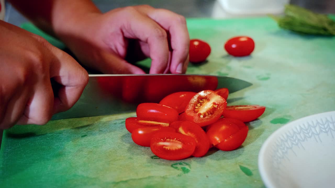 Authentic Italian food making process in traditional Italian restaurant, of a chef cutting tomatoes in the kitchen