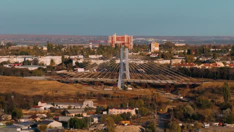 Close-up-shot-of-a-small-suspended-bridge-under-construction-near-city,-drone-shot,-4K50Fps