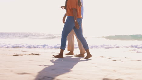 legs, sunset and a couple walking on the beach