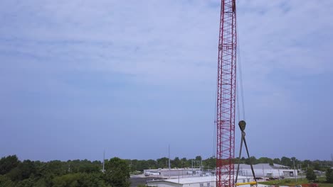 ascending aerial view of construction crane on job site