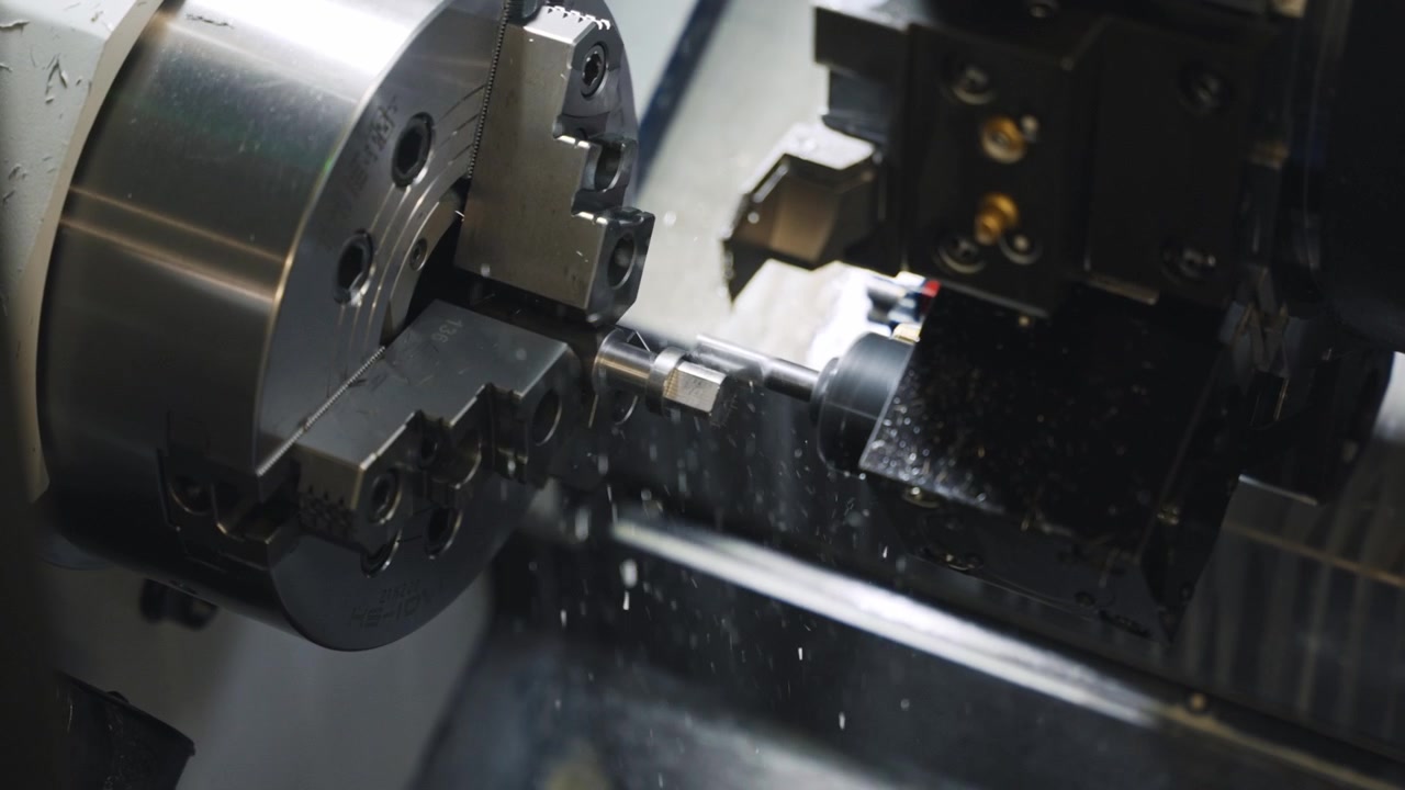CNC lathe machining process inside industrial machine, showing close-up metal turning, cutting tool movement, rotating workpiece, precision manufacturing and automated factory production.