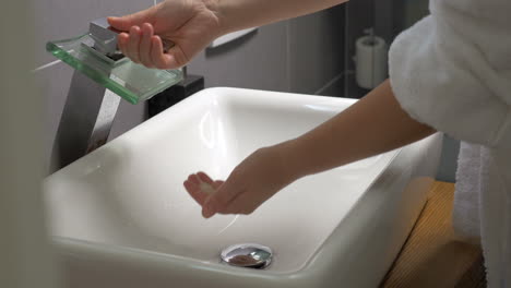 Washing-hands-in-the-bathroom