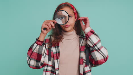 investigator teenager child girl kid holding magnifying glass near face, big eye searching analysing