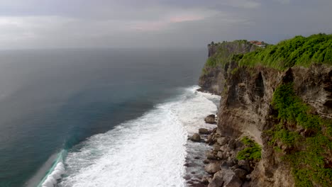 Aerial-birds-eye-flight-over-cliffs-in-Bali,-Indonesia