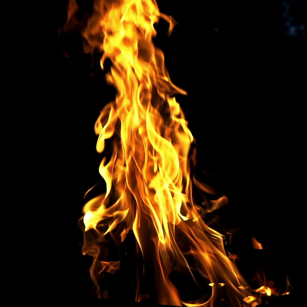 Slow motion of fire at bonfire in the dark, closeup