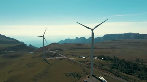 drone aerial view of two wind turbine generators located on high altitude mountains