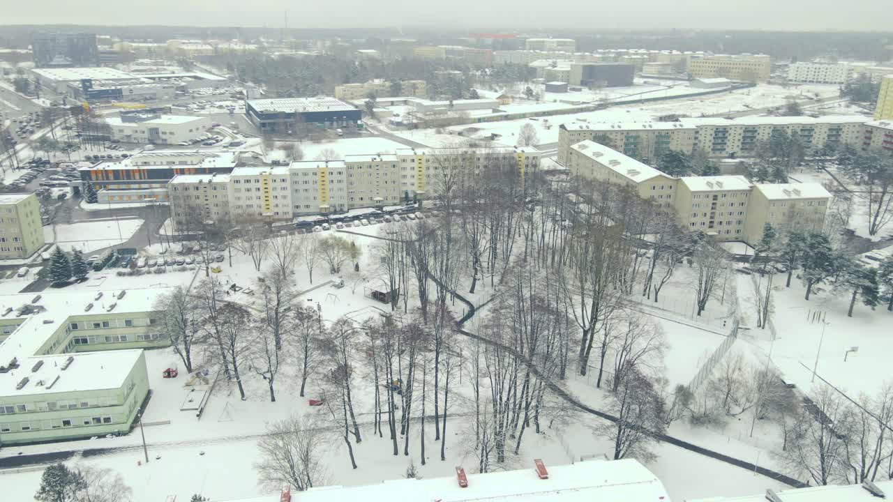 Aerial drone footage slowly moving from left to right and revealing Mustamäe district in Tallinn with large soviet reconstructed apartment building and a high school called Tallinna Tehnika Gümnaasium
