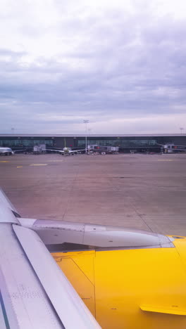 view from a plane window of the sky with the wing of the plane in shot in vertical