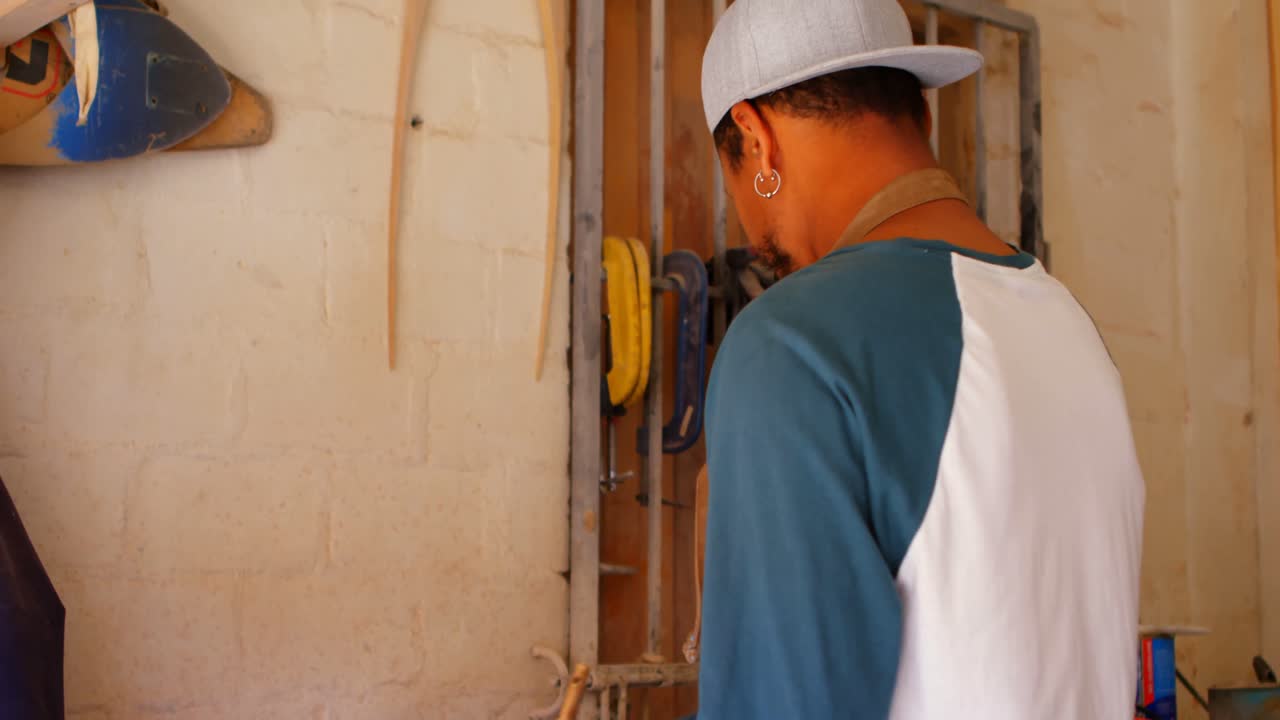 Surfboard maker polishing surfboard 4k