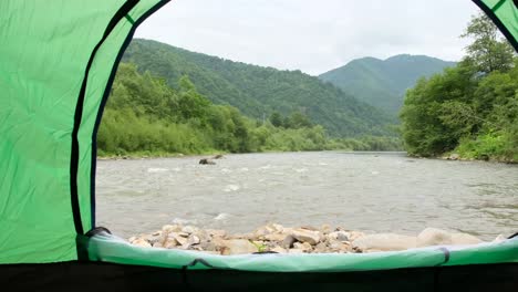 a beautiful view from a tent on the bank of a raging mountain river a beautiful view from a tent on the bank of a raging mountain river the beauty of the ukrainian carpathians