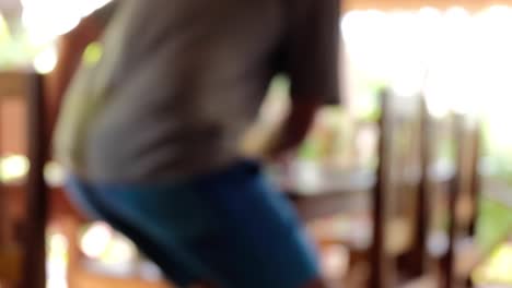 a person walks to a dining table and sits down to eat on a tropical island