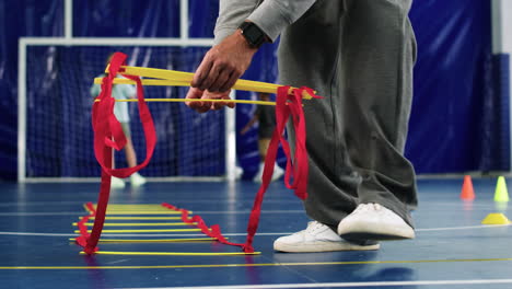 man putting objects on the floor