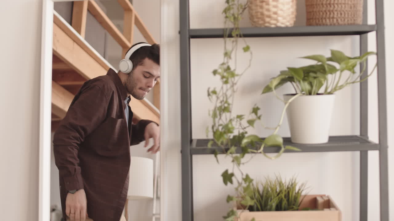 Joyful Young Man Dancing in front of Mirror