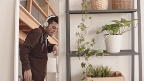 joyful young man dancing in front of mirror
