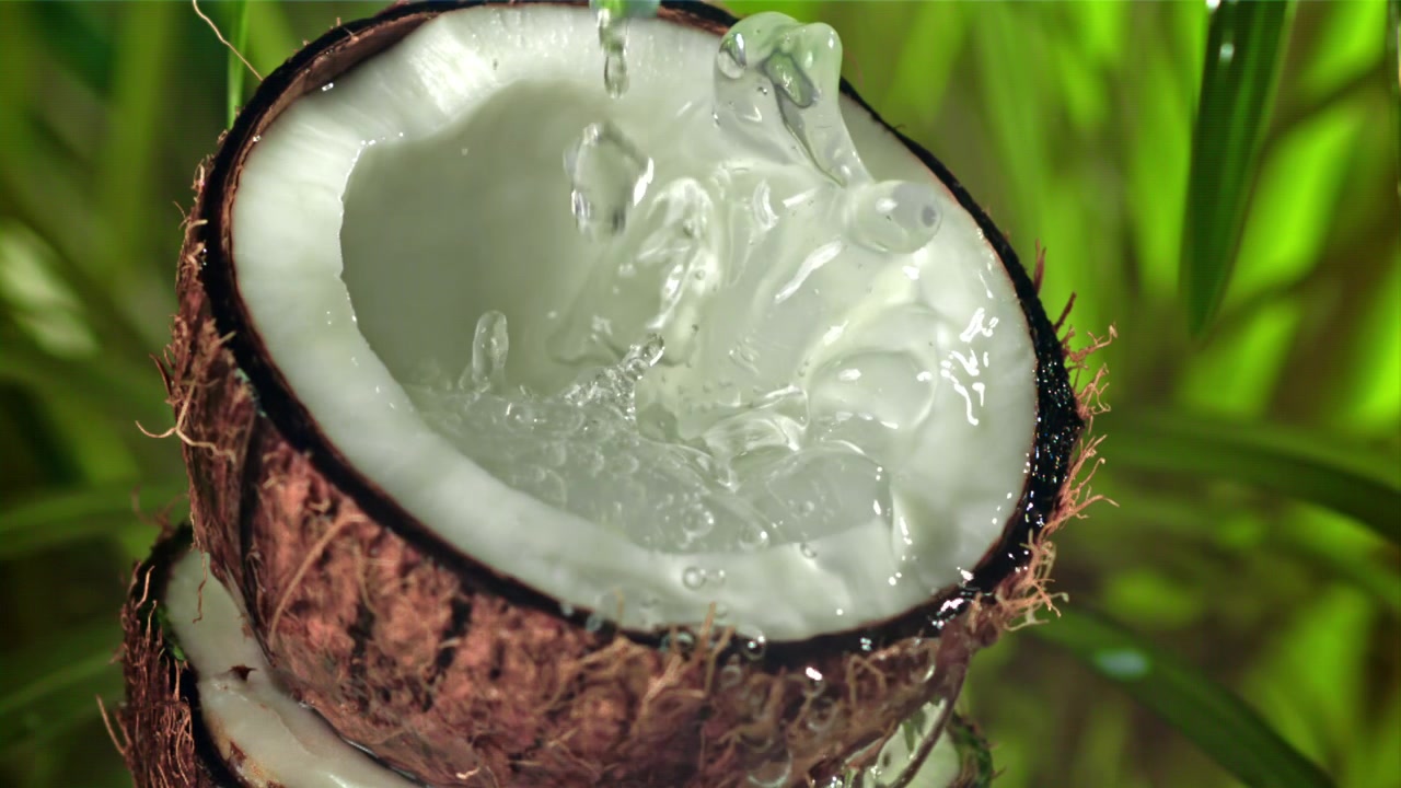 Fresh Coconut Water Pouring and Splashing in Slow Motion