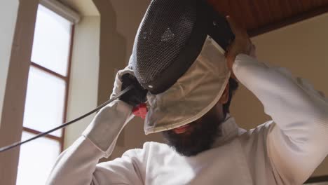 fencer athlete during a fencing training in a gym