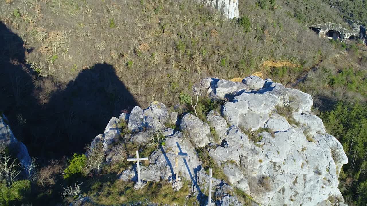 Christian crucifix wood cross on top of cliff. Reveal shot. Motovun, Croatia