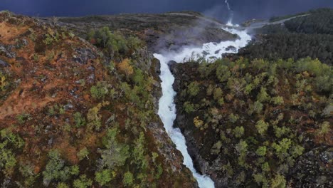 Dramatic-aerial-flying-over-majestic-waterfall-in-Norway