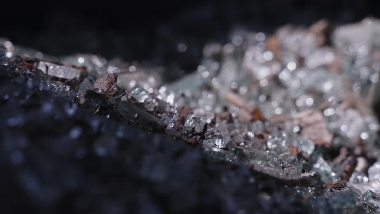 Closeup shot of smashed glass for recycling at old factor, dolly out