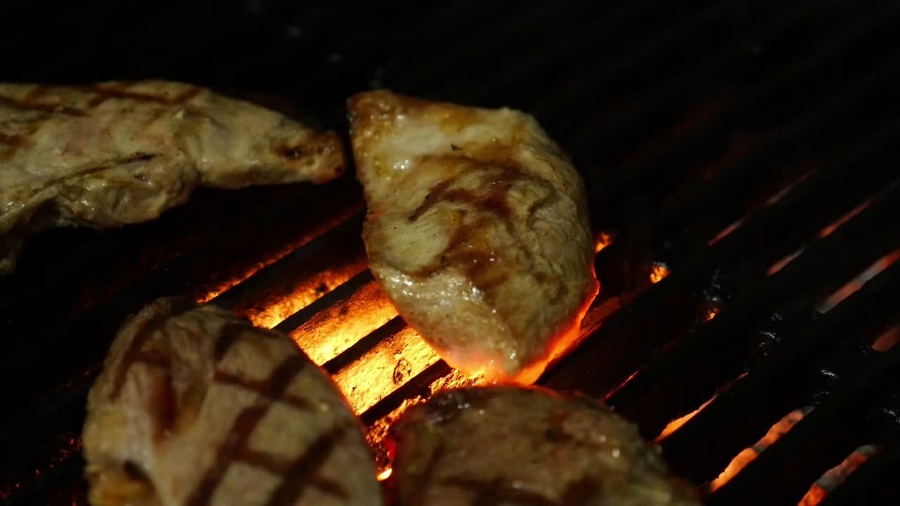 Meat grilling over hot coals, creating perfect grill marks. Food cooked over an open fire, barbecue