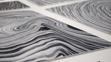 close-up of abstract black and white wavy patterns on multiple panels