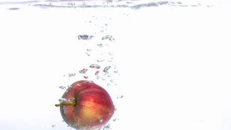 apple moving underwater in super slow motion