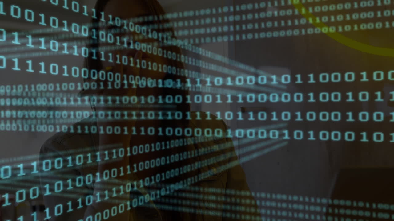 In school, person working on computer with binary code animation overlaying screen